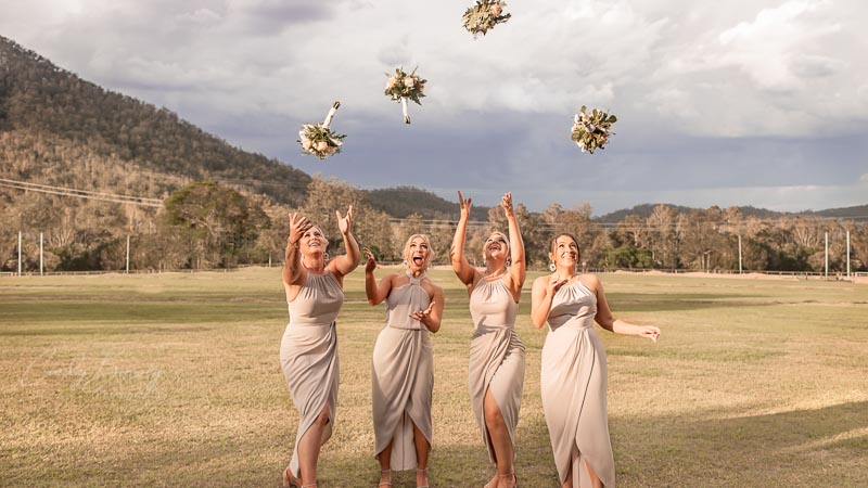 bridesmaids-throwing-bouquets-in-air