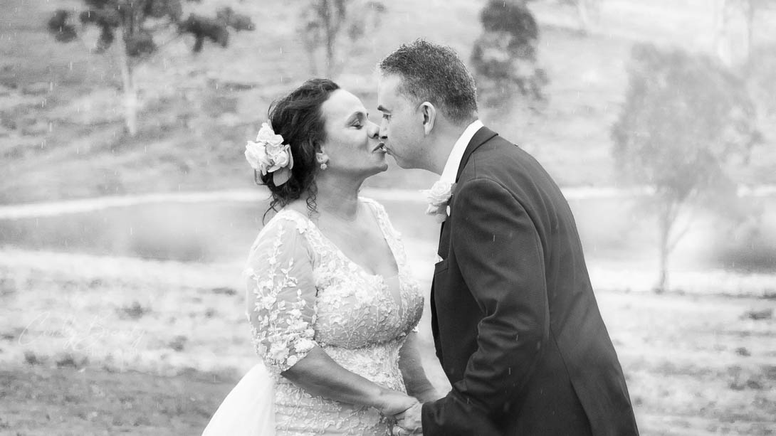 black-white-photo-of-couple-kissing-in-rain