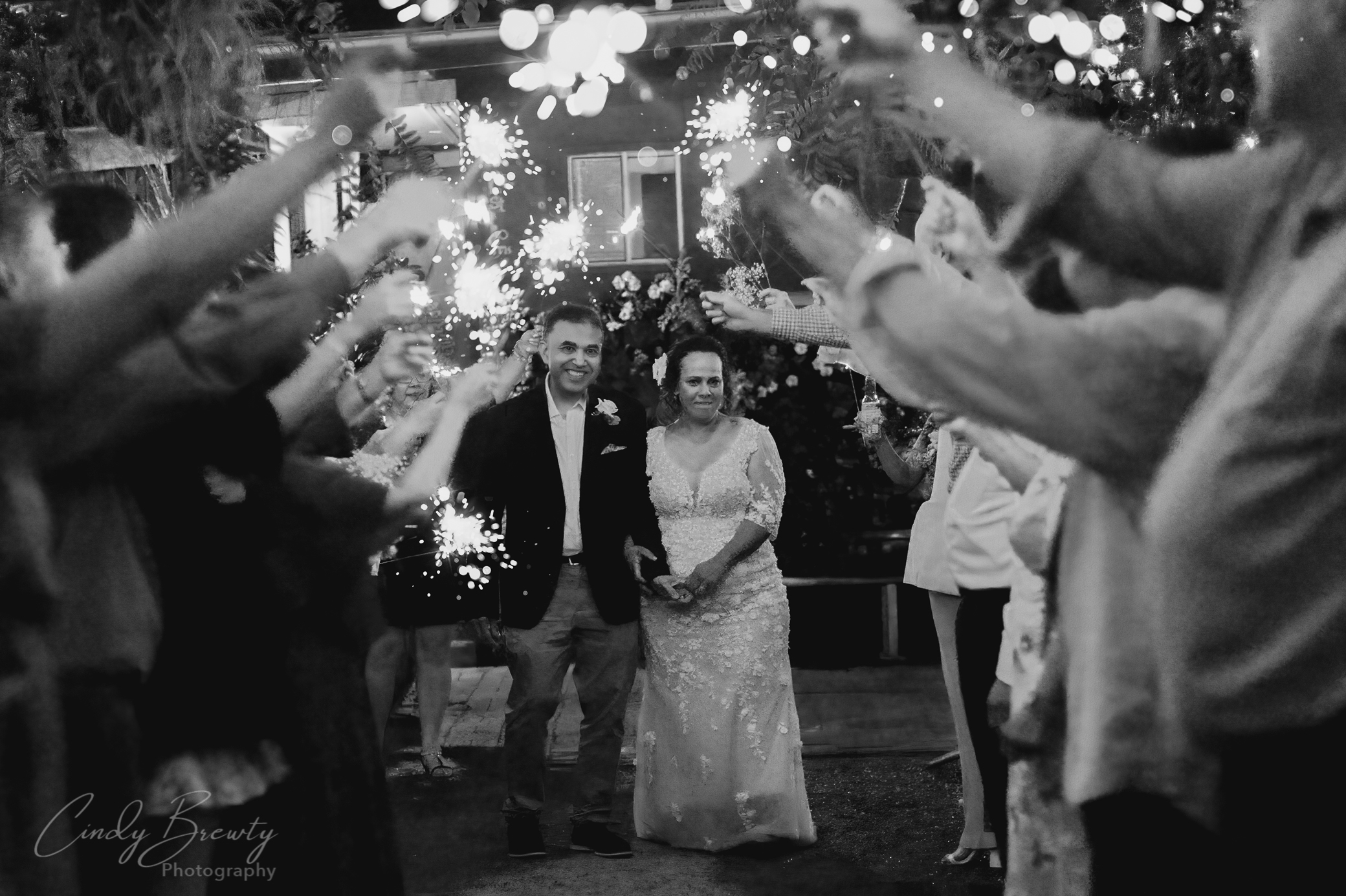 Black & white photo of wedding reception exit photos with sparklers