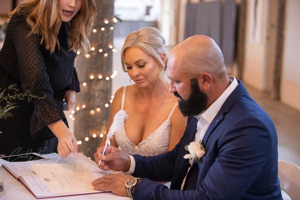 Bride & groom signing registry