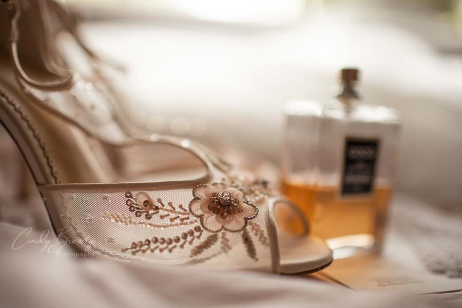 Close up of shoe & Chanel perfume bottle